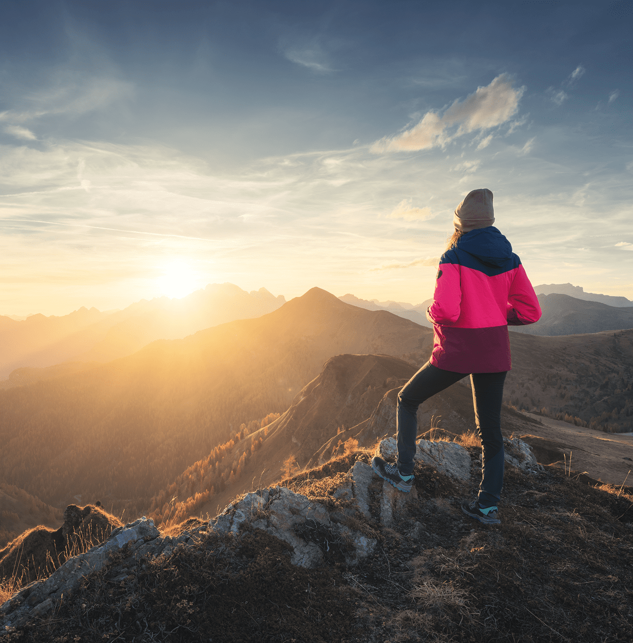 Woman admiring sunrise in mountains