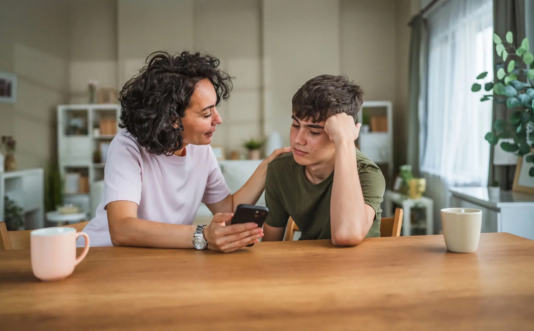 Mother and son talking about tech and iphone